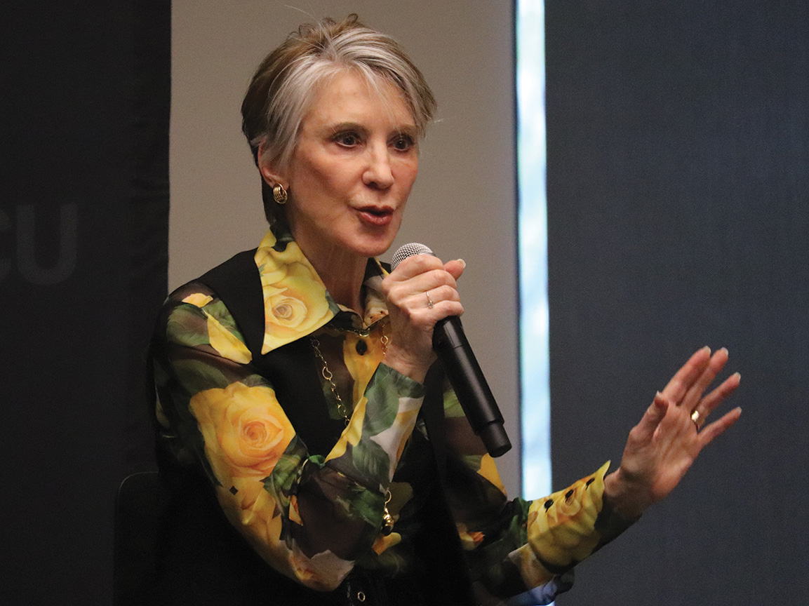 Carly Fiorina speaks into a microphone
