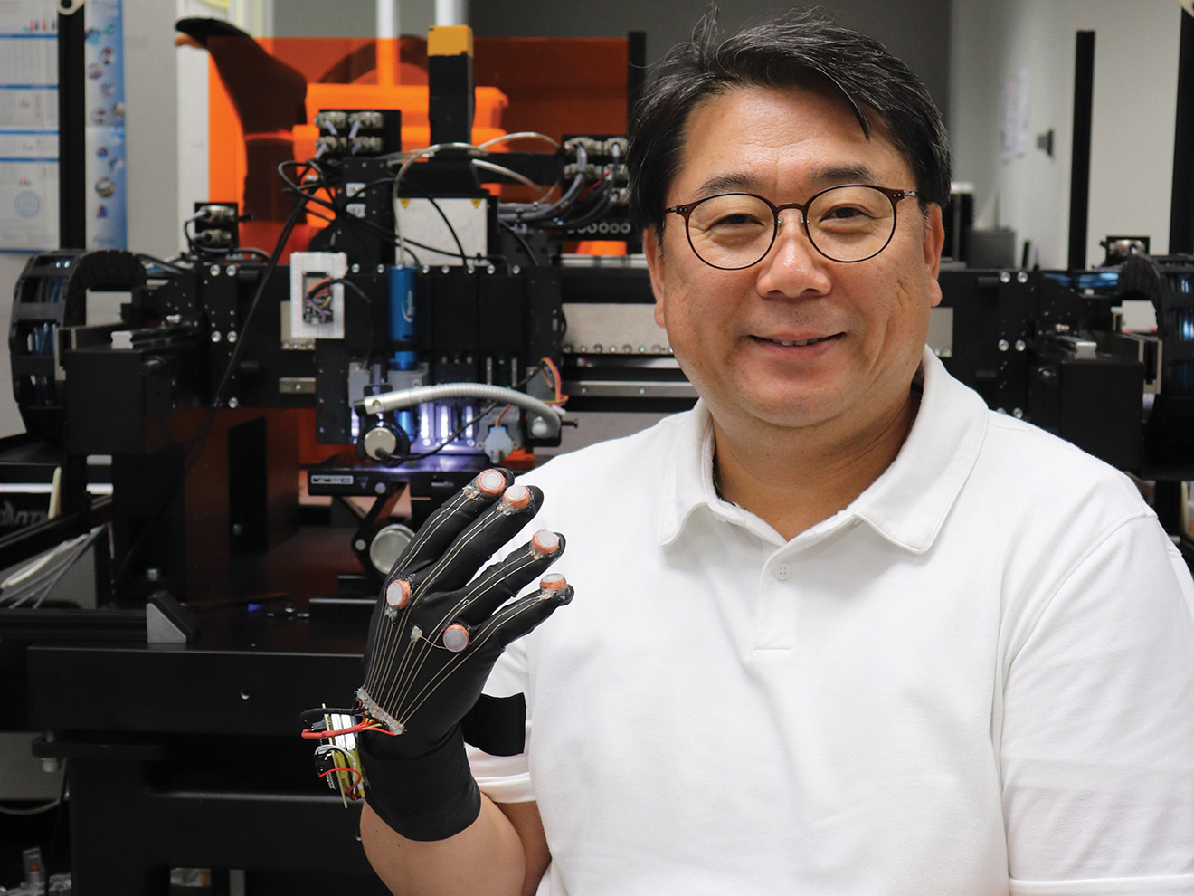 Daeha Joung in a lab wearing a medical device on his hand