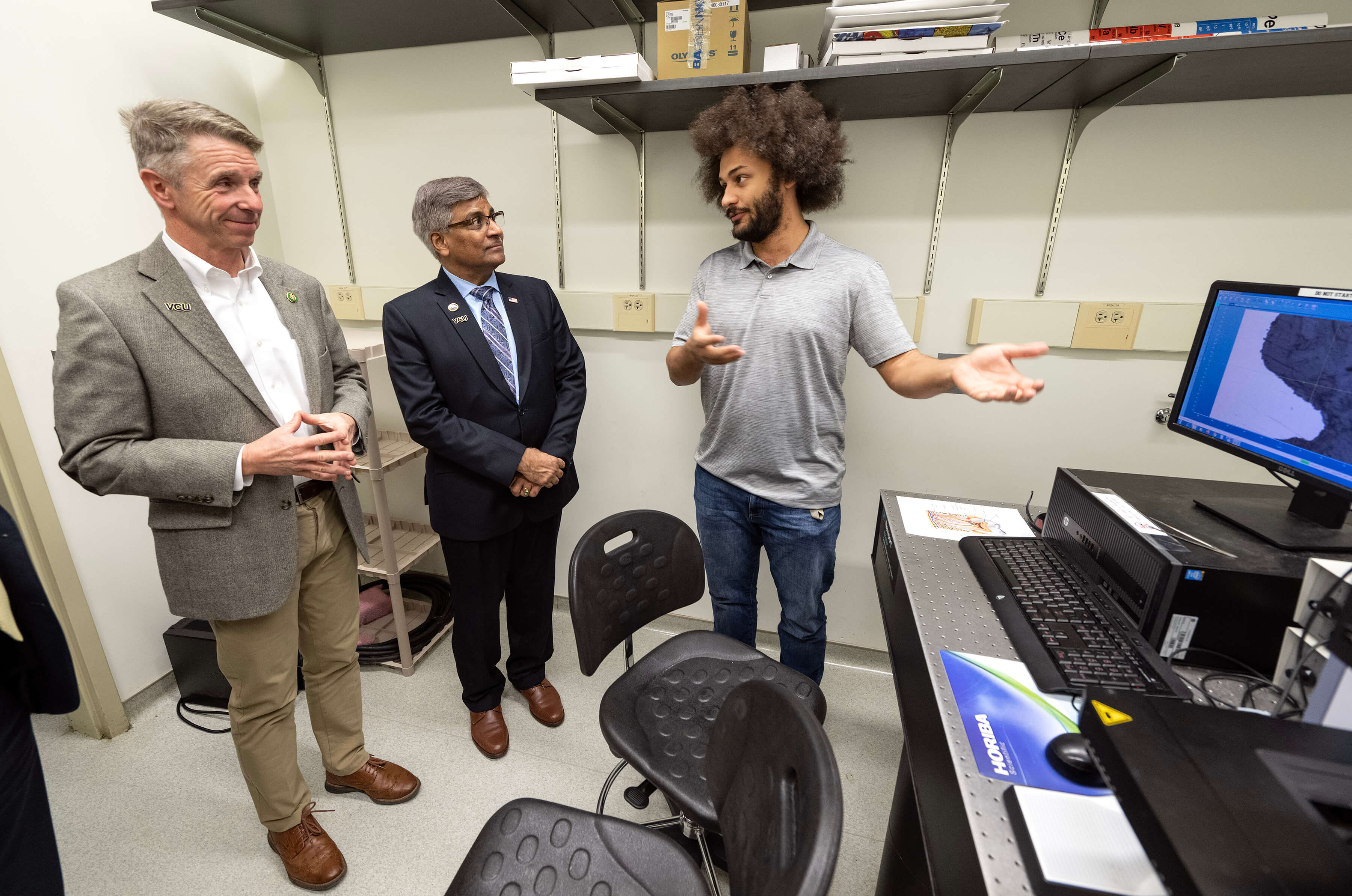 Sethuraman Panchanathan, Ph.D., director of the National Science Foundation (center) stands with two other people in front of a desk