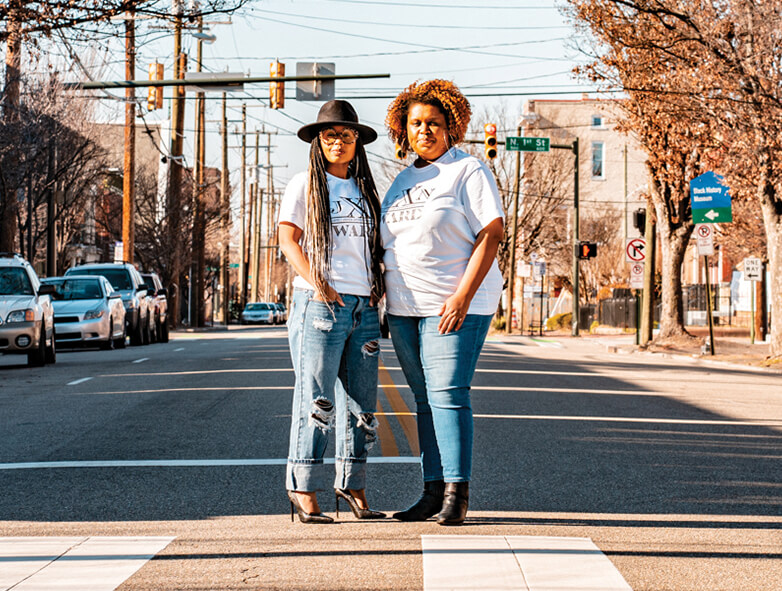 Sesha, left, and Enjoli Moon stand in a crosswalk on a Richmond city street