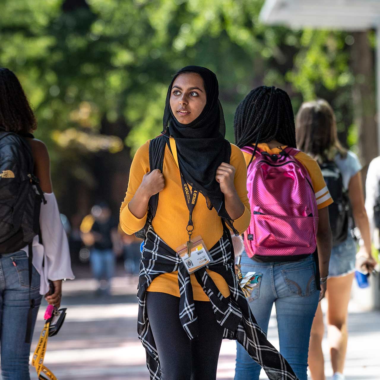 v.c.u. students walking outside cabell library