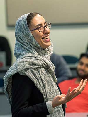 a student delivering a presentation in a v.c.u. classroom