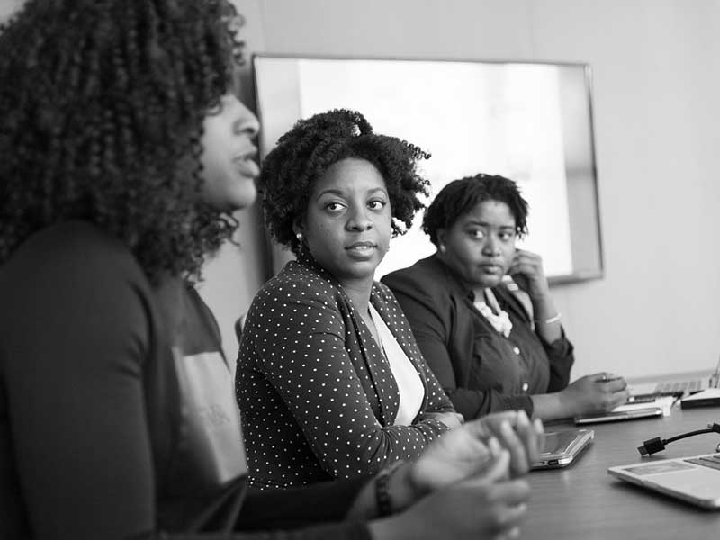 three women in a business meeting