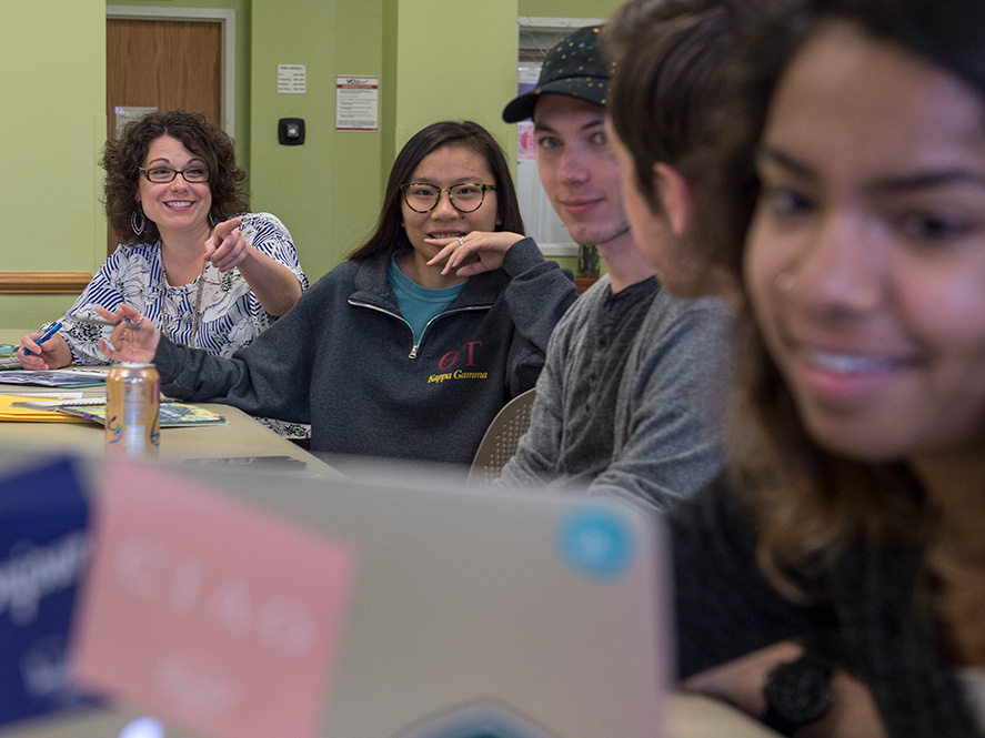 Smiling students sitting at a desk