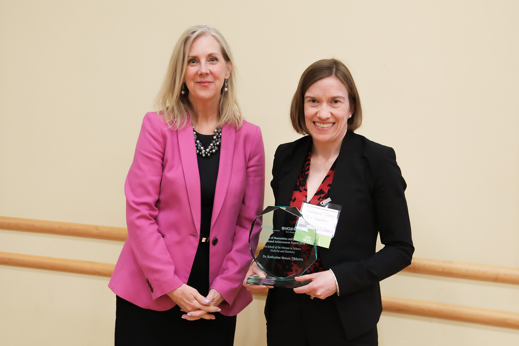 Katharine Tibbetts (right), stands beside CHS Dean Catherine Ingrassia, holding her professional achievement award