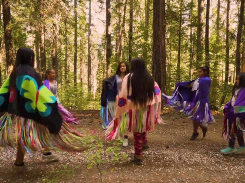 a group of indigenous women performing a ritual dance