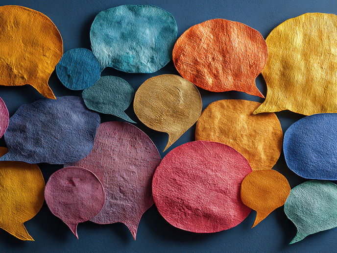A collection of colorful, textured speech bubbles in various sizes—including shades of orange, yellow, pink, blue, and teal—arranged on a dark blue background.
