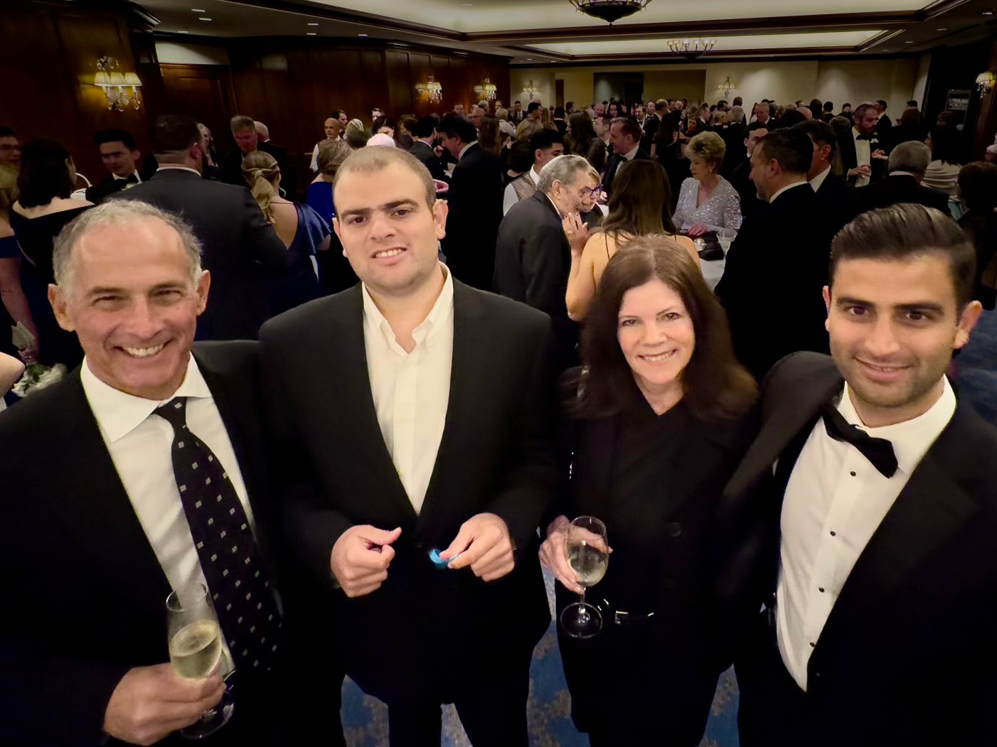 Peter Zucker stands with three other people at an event