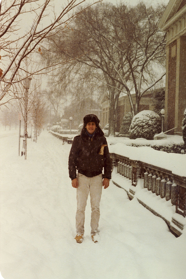 Peter Zucker stands in the snow on a city sidewalk
